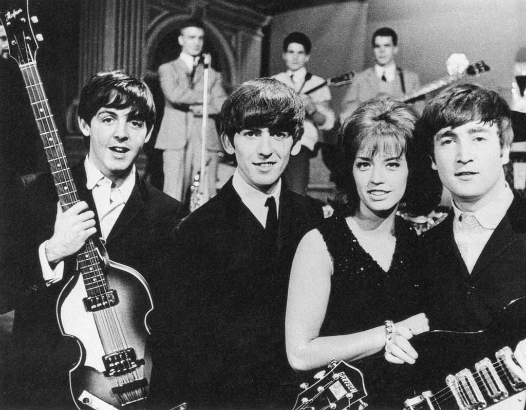 Early photo of Beatles: Paul McCartney, George Harrison, and John Lennon with Lil' Babs